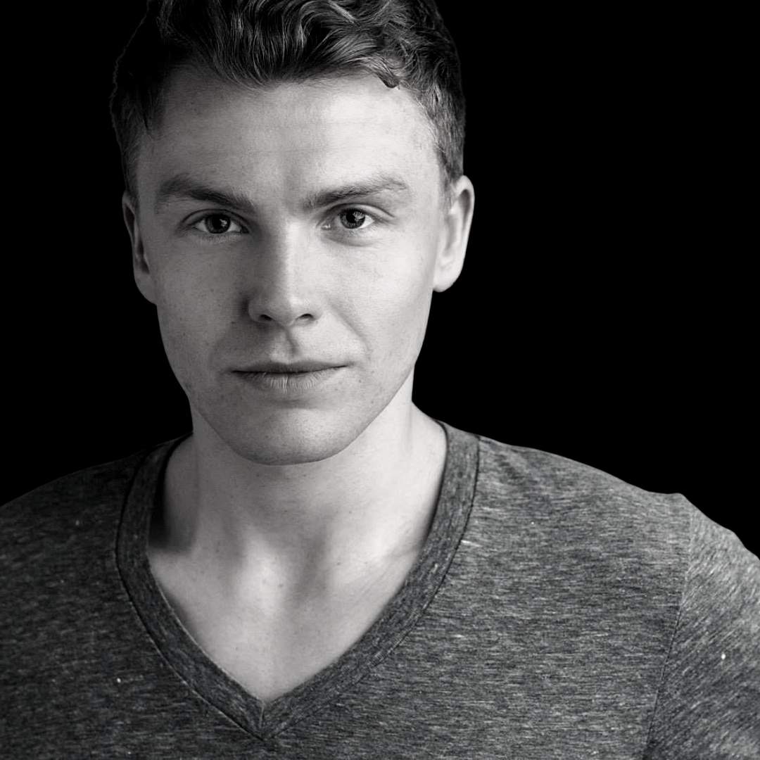 A black and white image of Michiel van Echten - Michiel is wearing a greay V-neck t-shirt with a nuetral expression.