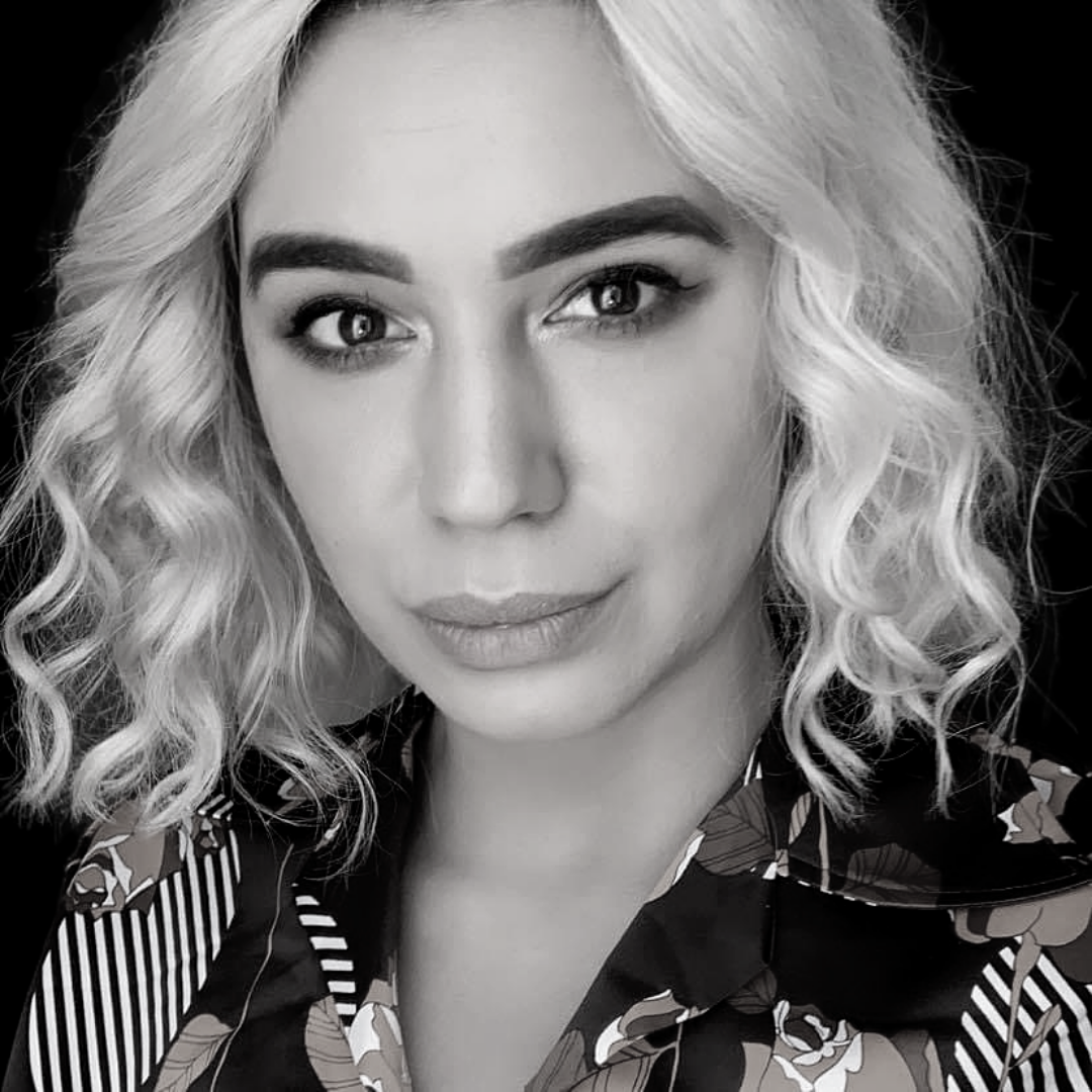 A black and white image of Stevie Greeks - Stevie is wearing a 70s print shirt and in the words of Tyra Banks on next top model is "smizing".